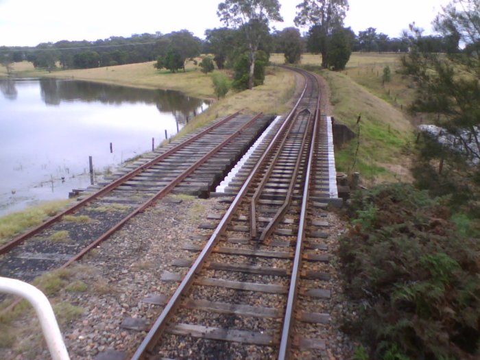 The view from a southbound train about 2km to the north of Bee Siding. The remains of the double line are still present at the bridge.