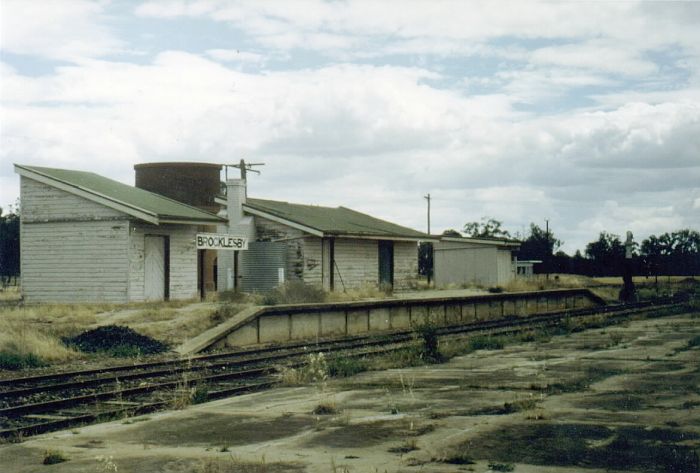 
Brocklesby boasted a grain siding and a goods siding through it's working
life.  Note the water column still survives at the down end of the
platform.  The concrete pad in the foreground is the floor of the one-time
grain shed.

