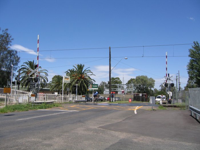 The road-side view of the level crossing at the down end of the station.