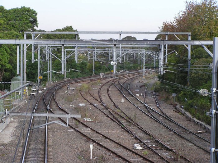 The view looking south from the Epping Road overpass, showing the three tracks through Epping Station becoming four tracks for the trip to Eastwood. Also note an unused siding on the right-hand side of the photo and a rusty-looking crossover in the centre.