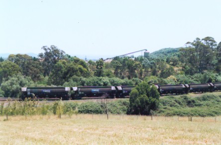 A photo showing stationary coal wagons with the Glenlee colliery in the background.