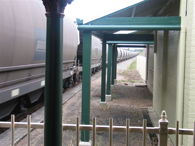 
The fenced-off older part ofthe up platform is dwarfed by the passing coal
hoppers.
