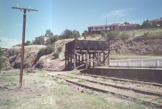 
Looking back to the Tumut end of the yard, still with the old water tank.
On the other side of the cutting is the big timber trestle
bridge.
