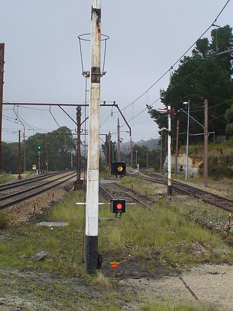 A closer view of the signal post with the semaphores replaced by fixed stop lights.