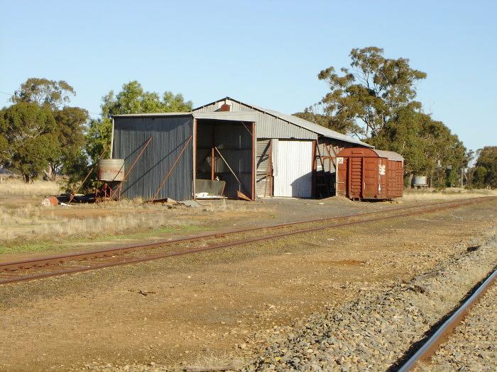 A shed and bogie-less wagon at the south end of the yard.