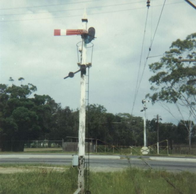 
The signals protecting the Hume Highway level crossing, in this view
looking towards the racecourse..  In the foreground is the Down Home and in 
the background is the Up Starting signal.  Both signal were controlled from 
the Racecourse Box.
