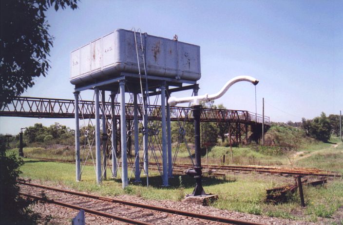 
At the down end of the platform are a large elevated water tank and
counterbalanced water column.  A second water column is visible in the left
distance.
