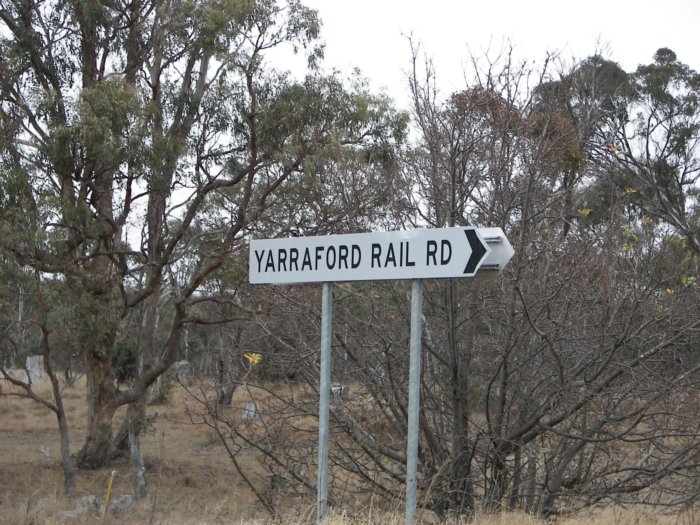 Sign on the main road pointing to the former station location.