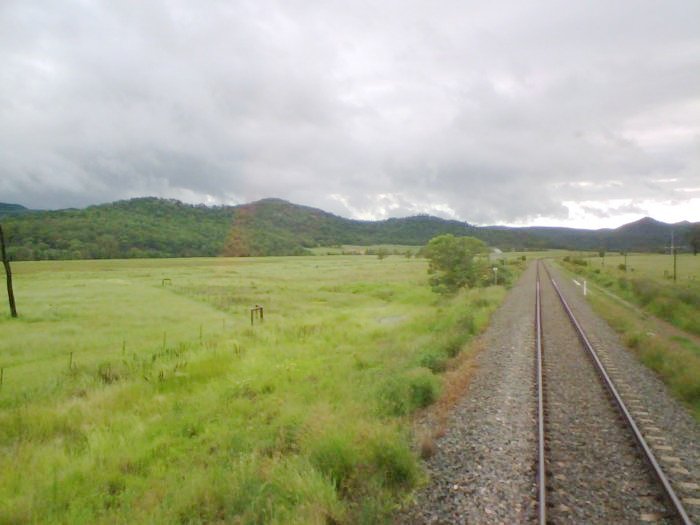 The view from a down train.The fence can be seen deviating to the left to accomodate the station that was never built.
