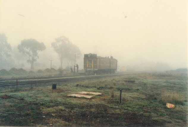 A Tin Hares has stopped in the mist. The former station is hidden in the mist behind the railcar.