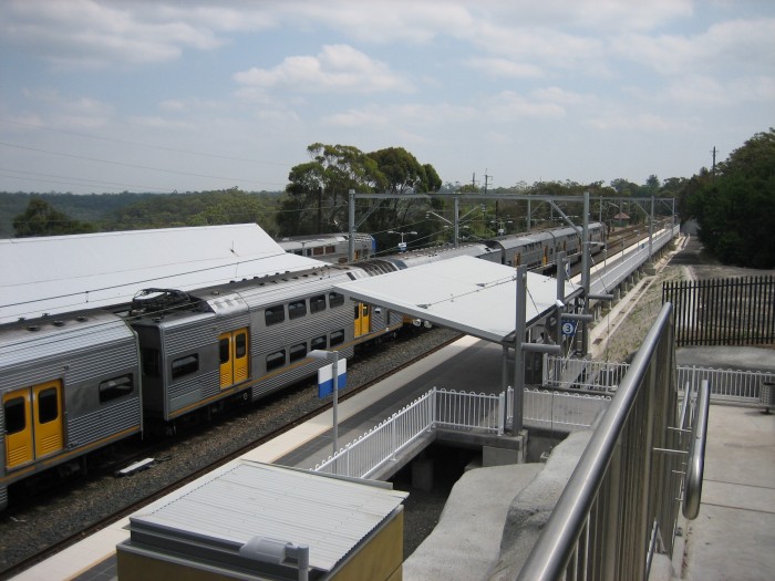 Berowra Station as seen from the new pedestrian overpass looking south. A Sydney bound Intercity express has just pulled into platform 1 while a terminating local service waits on platform 2. The newly opened platform 3 in the foreground allows north bound Intercity express trains to stop at Berowra while a terminating local service is at the station.