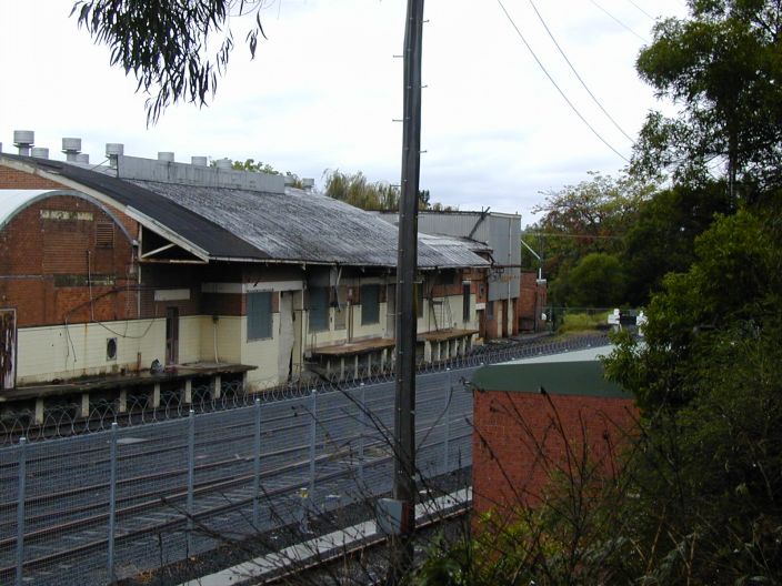 
The Nowra Dairy Company butter factory, which boasted rail access, lies at
the down end of the yard.  The razor wire in the foreground protects a
siding used to stable rolling stock from vandalism.
