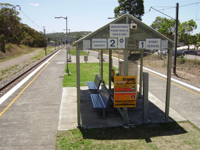 A view of the unattended station, looking north from the footbridge steps. The grassed areas add to the amenity to an otherwise "bare necessities" CityRail platform.