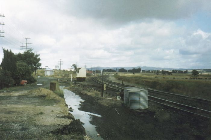 
The view looking in the down direction from the location of the platforms.
The goods siding remains in the background, with the B lever frame just
behind the water tanks.
