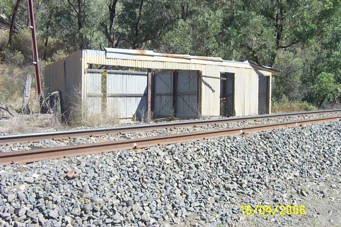 The gangers shed on the Down side of the line. On the left side of the shed is where the trolleys were kept On the right side of the shed is where the trucks from Brogans Creek quarry went up and around to the loading platform.