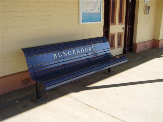 A modern bench seat on the platform.