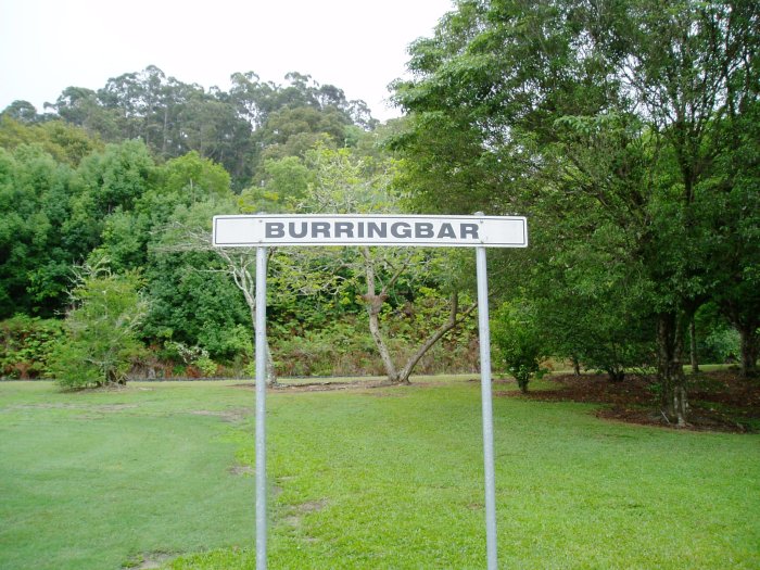 A modern station name board has been turned around to face visitors.