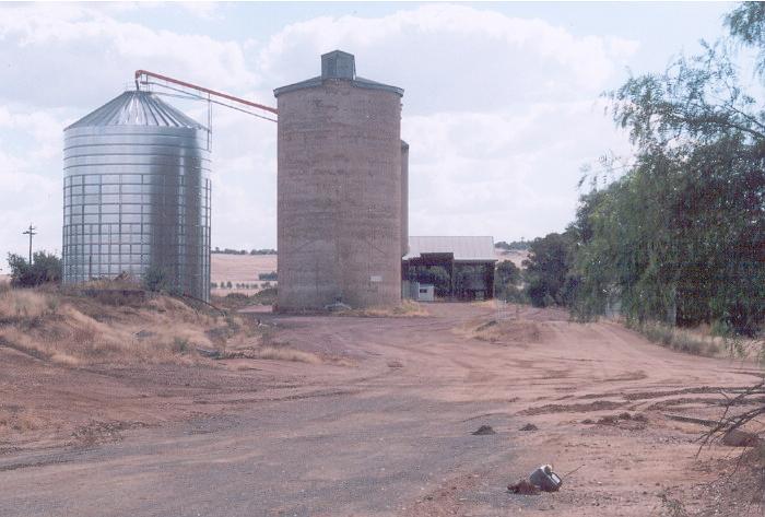 The view of the yard in 2005. A metal silo has been installed and much of the siding has been removed.