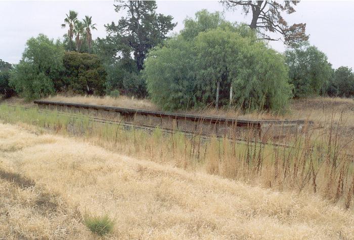 The platform at Burrumbuttock.  All buildings are long gone and only the support posts remain for the destination sign.