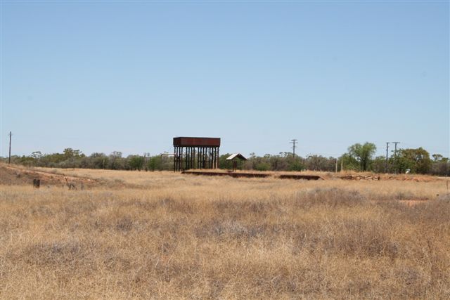 A view looking across at the platform, water tank and information board shelter.