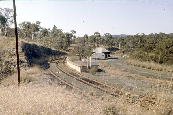 Captains Flat station from the embankment in 1986 shows rusty tracks and some vegetation beginning to grow on the platform.