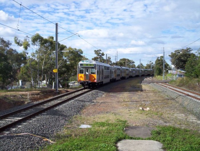 An S set makes its way towards Cronulla, as viewed from the down end of Caringbah. The points are roughly where the first car is.