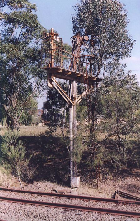 
The remains of a semaphore signal post near Cochrane.  Note also
the train trip at the base.
