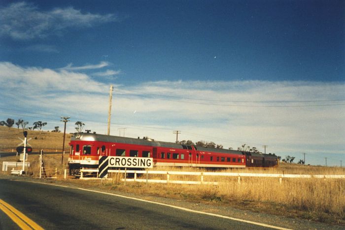 
A three-car diesel railcar set crosses the Monaro Highway at a now-lifted
crossing near Colinton.
