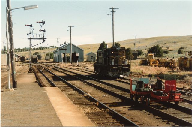 
A close-up of an unidentified 48-class loco and a rail trolley in the
yard.
