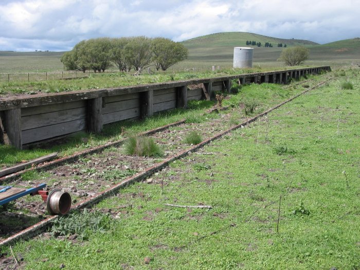 The view looking south along the wooden platform. The former goods siding opposite has been lifted.