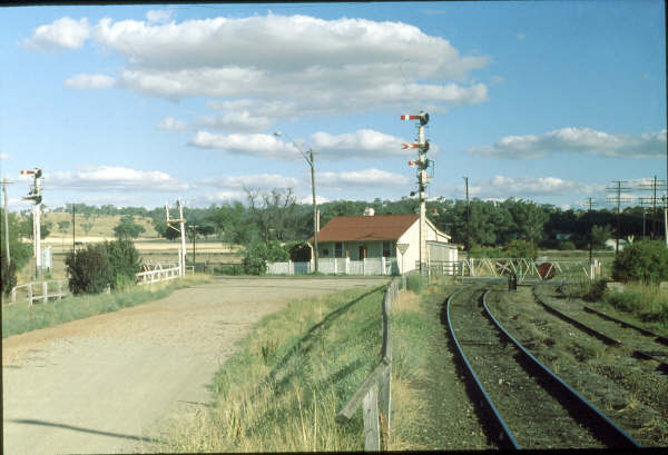 The scene in 1980 which shows the original Station Masters house and the manually operated gates. To the right the single line south and the left the up & down lines north.