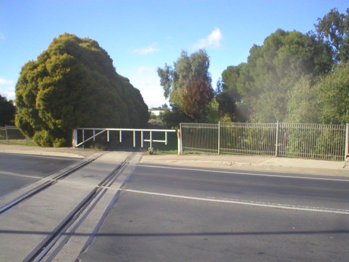 Level crossing of the Mid Western Hwy and Eugowra branch looking back towards Cowra at the western end of Cowra’s main street.
