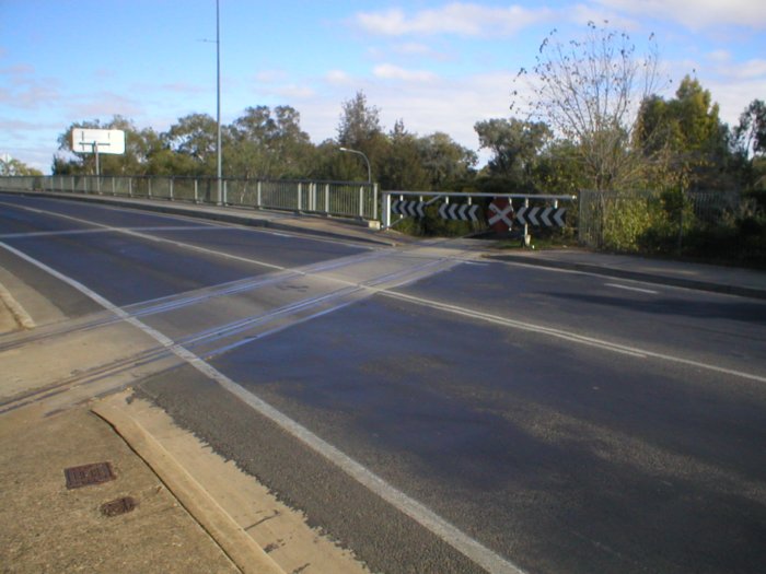 The Mid Western Hwy crosses the Eugowra branch on the level at the eastern end of the main street of Cowra. This view shows the Eugowra branch looking towards West Cowra.