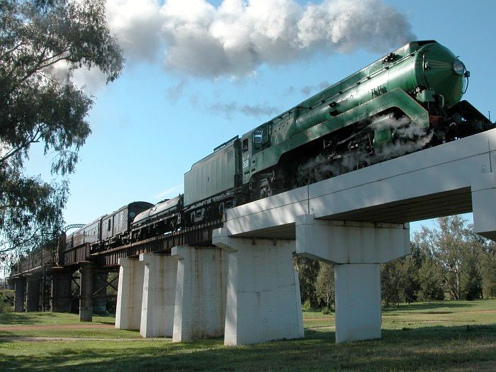 
3801 leads a tour train off the Macquarie River bridge, to the west
of Dubbo.  This is the view looking back towards Dubbo.
