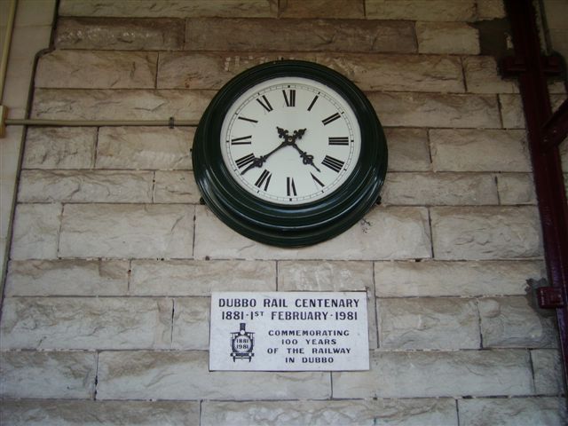 A commemorative clock on the station building wall.