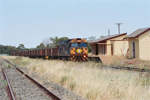 
An NR locomotove heads an ore train through the station.
