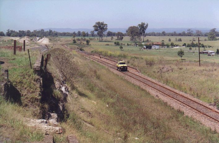 
A maintenance "hi-rail" vehicle passes the remains of the up platform.

