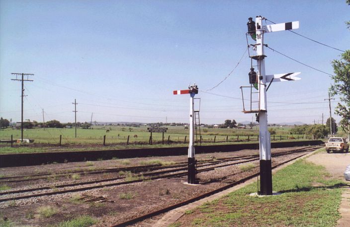 
Platforms and semaphore signals.  The sign on the down platform at
the back reads "South Maitland Railways - East Greta Junction".
