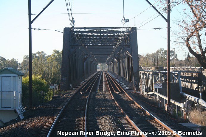 The view from the front of a City-bound V Set looking in an easterly direction through the box girder bridge over the Nepean River at Emu Plains. The original bridge can be seen to the right of the rail bridge and is now carries the road traffic over the river.
