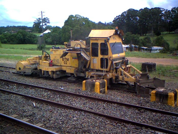 A ballast regulator stored in the siding for track maintenance.