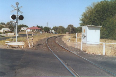 The level crossing at the up end of the location. The station is located just around the bend.