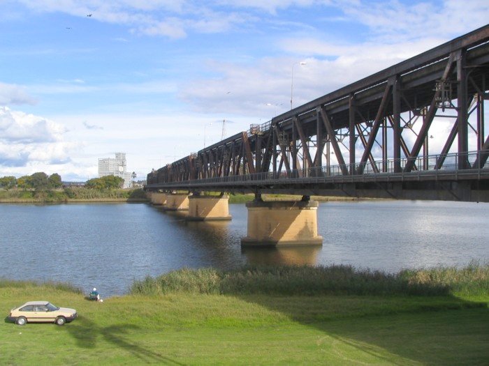 The unique double deck Grafton Bridge spanning the Clarence River.  The sugar loading facility at Grafton City station can be seen to the south.