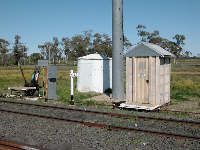 
The lever frame and staff hut stand adjacent to the 573 km post.
