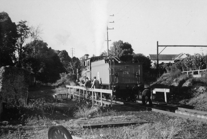 The turntable was located behind Platform No.1 (the Up Shore Platform). The occasion was the day of official photographs of the Vintage Train at Homebush Abattoirs. Locos 1243 and 1709 had run light engine to Hornsby to pick up the Vintage Cars that were stored in Hornsby Car Sheds. Loco 1243 (re-numbered 176) had just been turned on the turntable.

This location is now the eastern side commuter car park.
