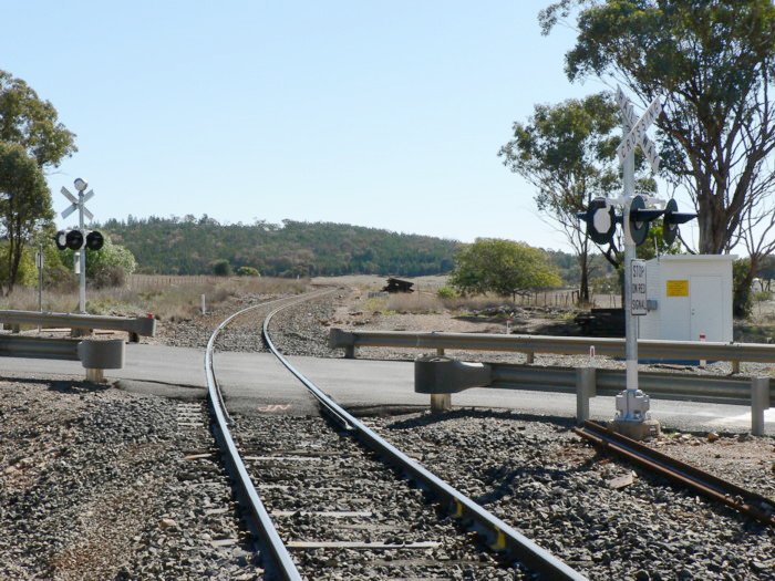 The view looking west. The former station was located just beyond the level crossing.