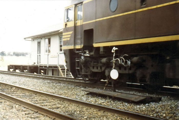
This shot taken in 1980 at Kapooka shows a working of bygone days on the south
with 42203 which has just changed staffs on the Automatic Staff
Exchanger.
