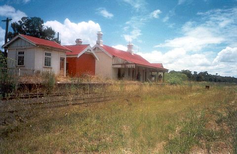
The station, as viewed from trackside.  Weeds in the line show that the
line is not in use.
