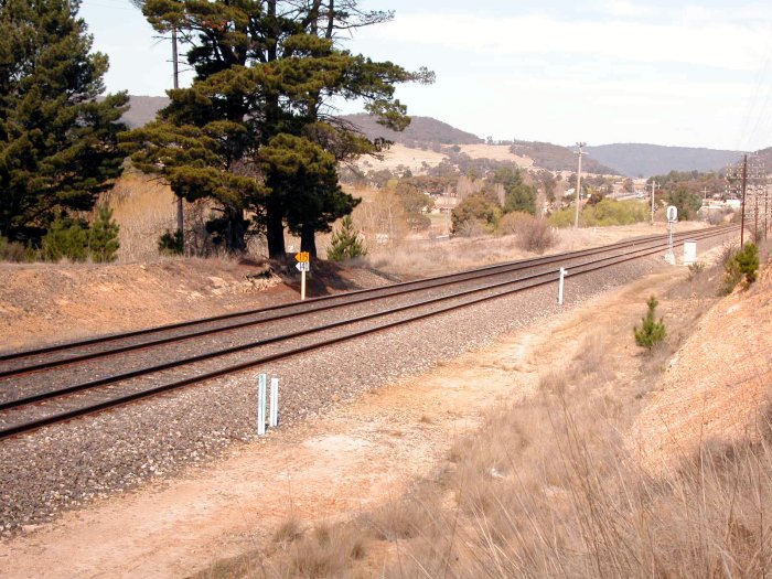 The location of the former station, which consisted of a pair of side platforms near the two large trees.  This is te view looking back up the line towards Lithgow.