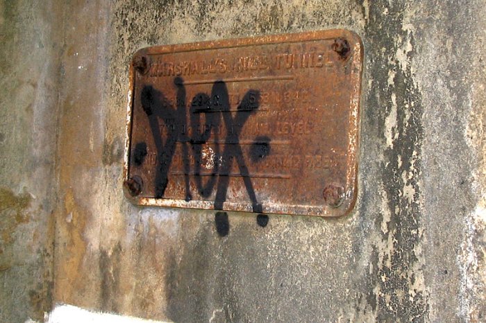 An identification plate bolted inside the tunnel.