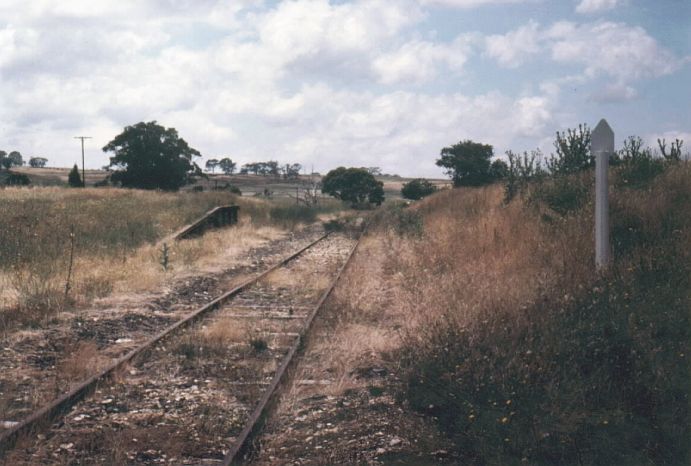 
The view looking back towards Goulburn.  The loading bank is on the left,
and the one-time station location is at the right foreground.
